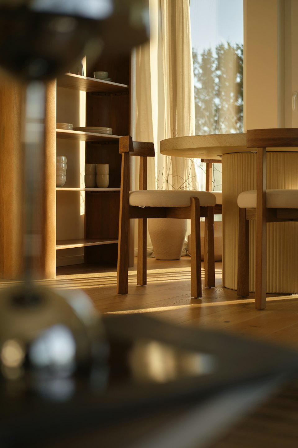 Modern wooden chairs and a concrete table in a dining room.